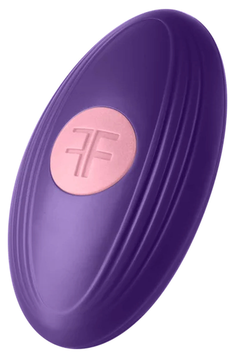 Wireless remote for the FemmeFunn Versa Bullet, oval ribbed puck with a single FemmeFunn logo button.