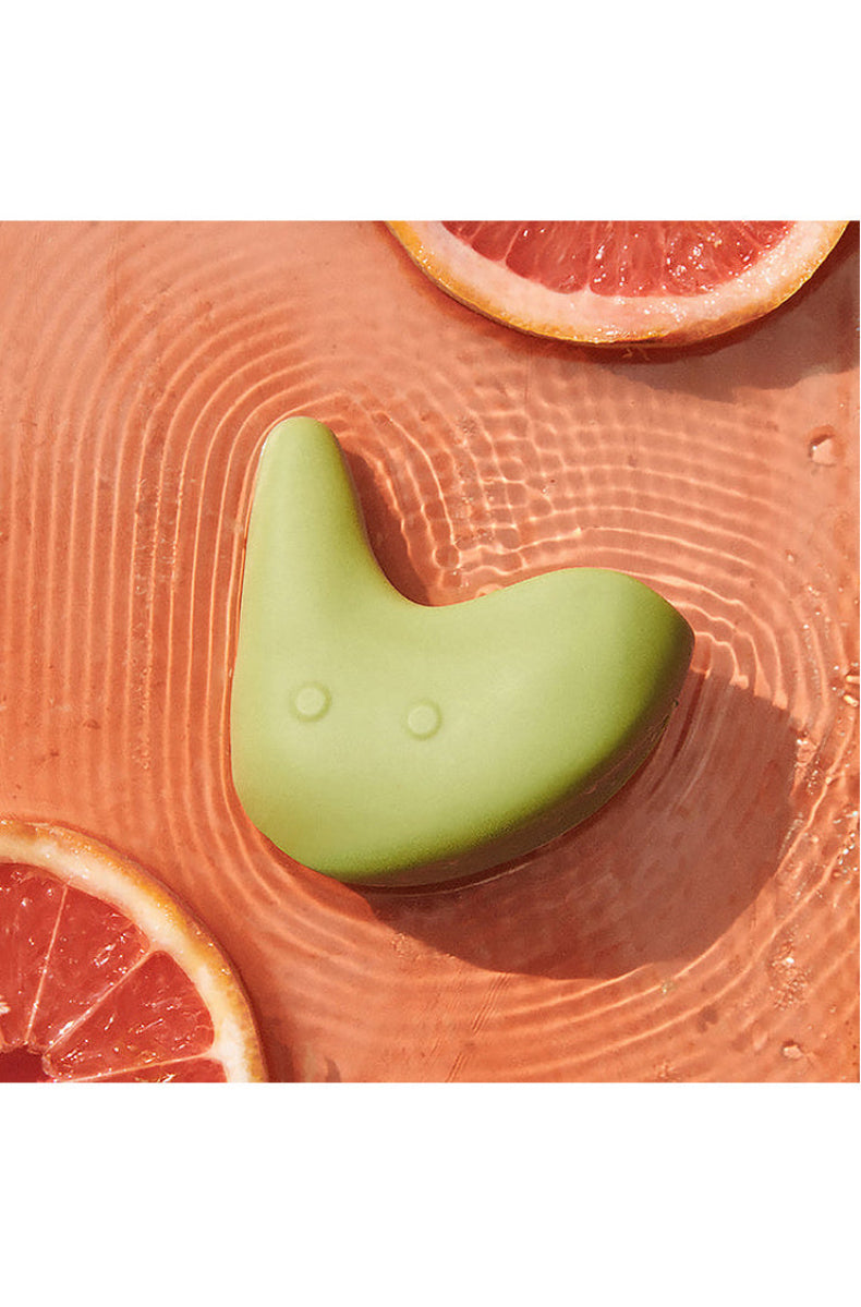 Top down view of the green Kiwi massager showing its curved shape and two control buttons.