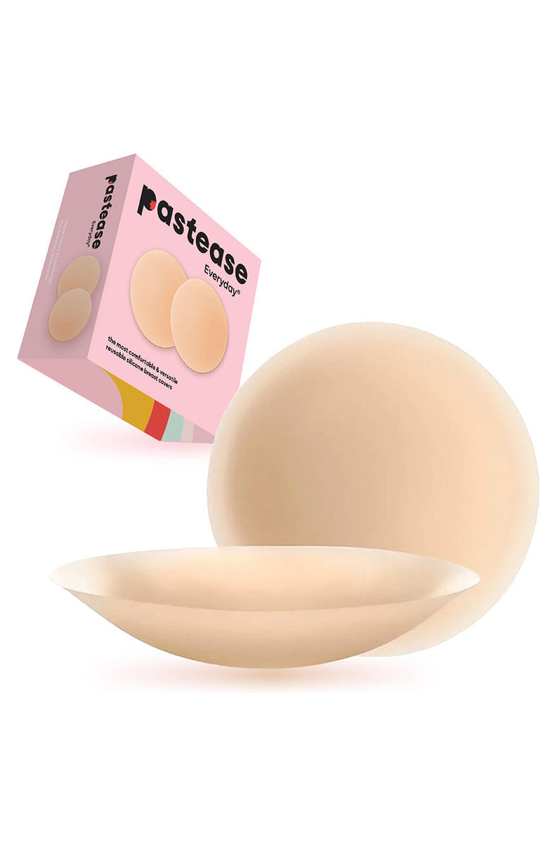 Light tone round silicone nipple covers beside their retail box