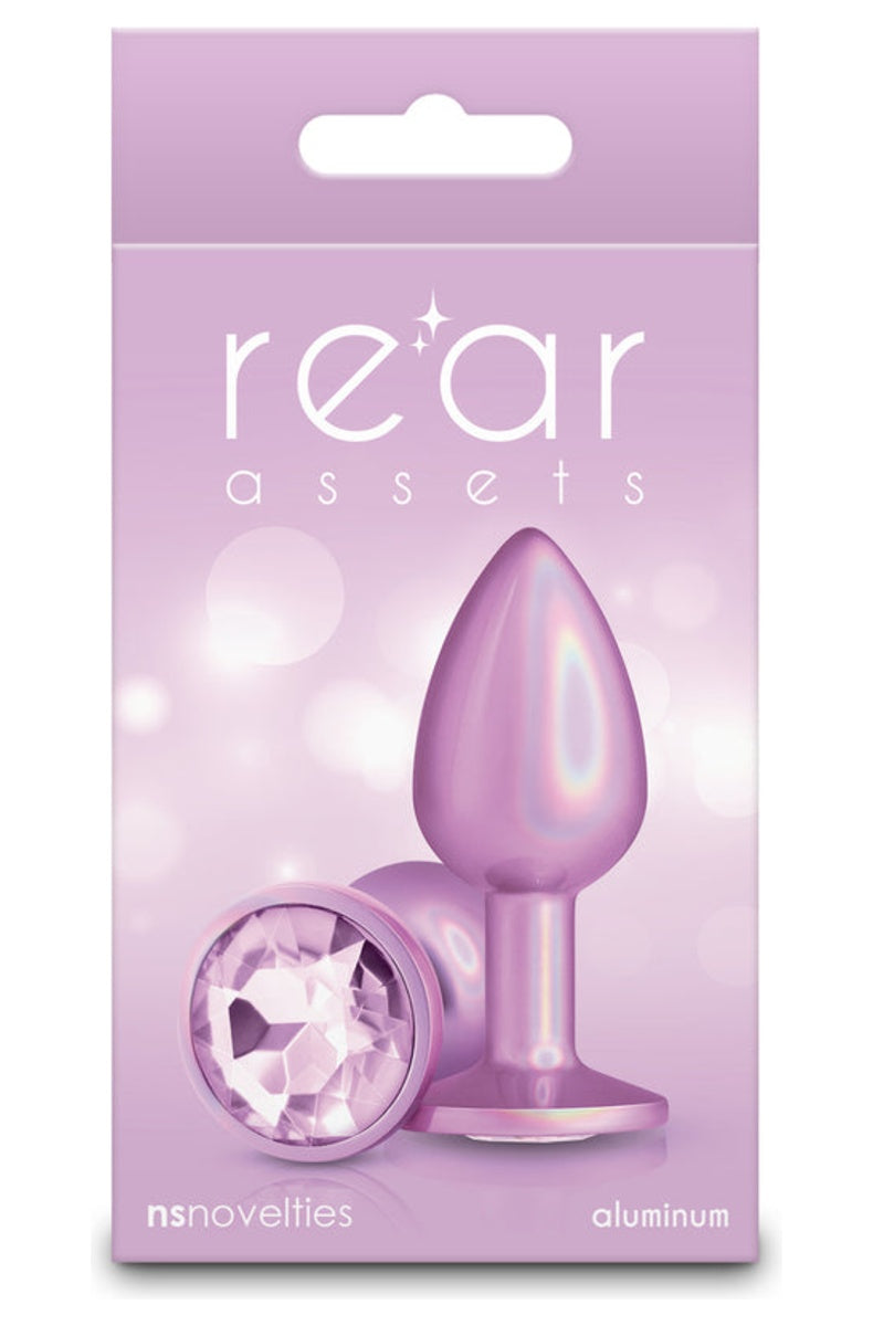 Iridescent pink metal butt plug in its retail box, plug and pale pink gem base shown on the front