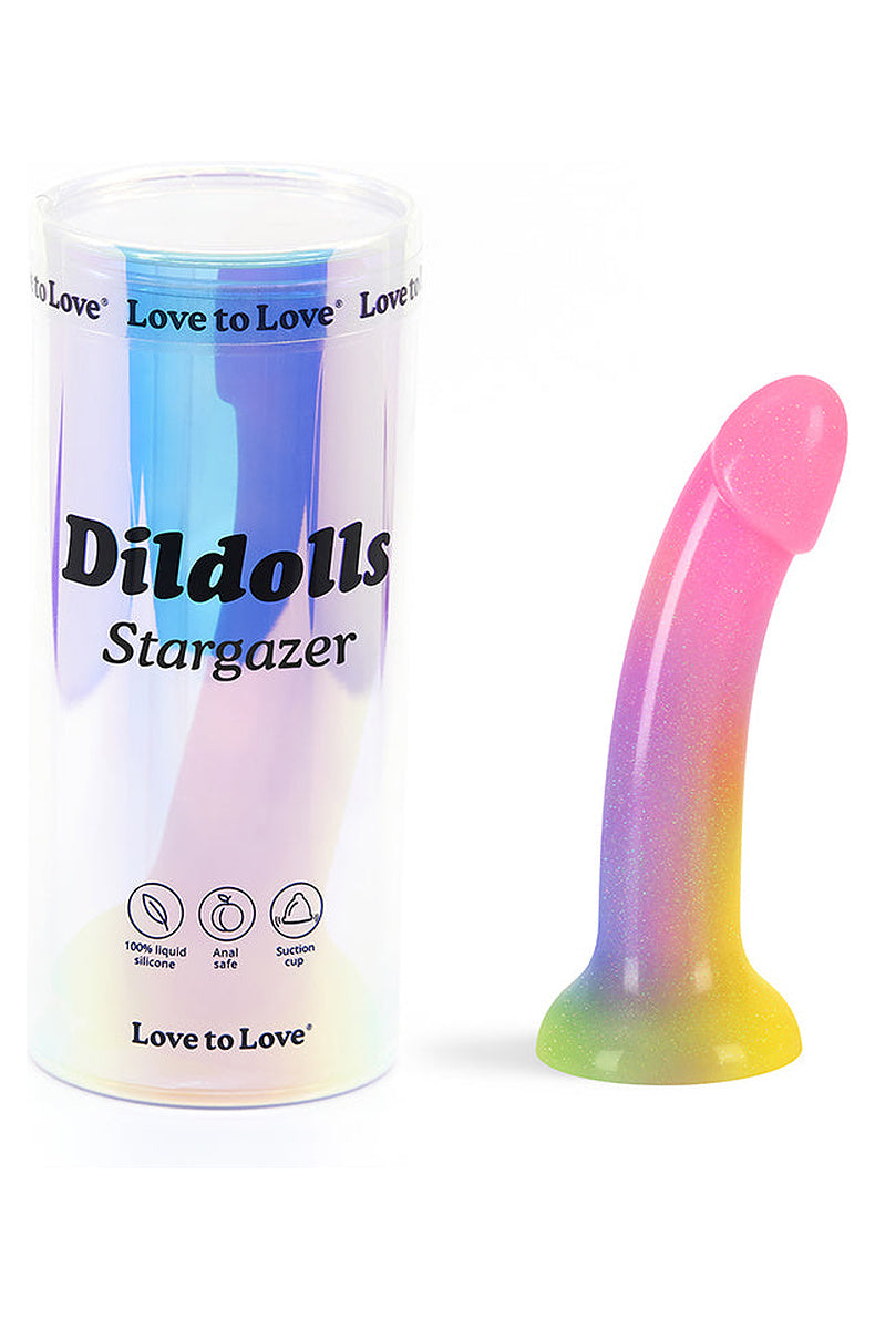 Rainbow glitter silicone dildo next to its holographic tube packaging