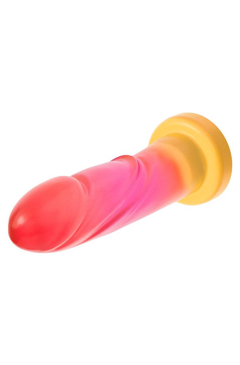 Pink and gold ombre dildo lying on its side, head forward