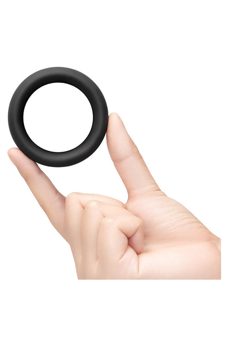 b-Vibe Snug Ring held between two fingers for scale against a white background