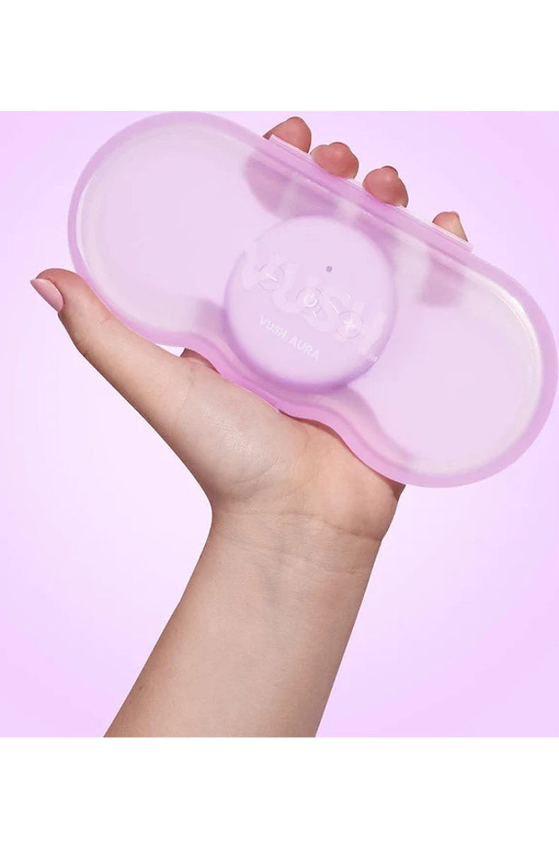 VUSH Aura hard clamshell travel case held in one hand, showing its compact size.