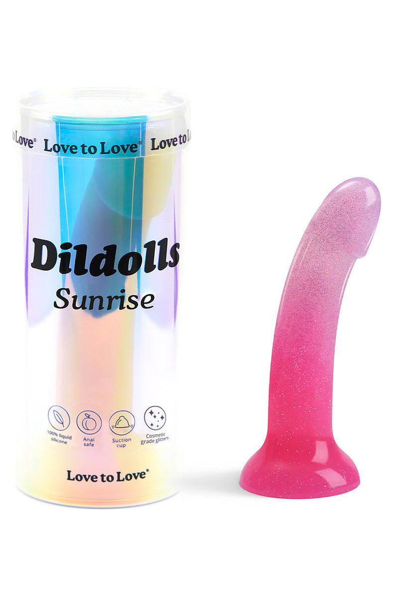 Pink ombre glitter silicone dildo next to its holographic tube packaging