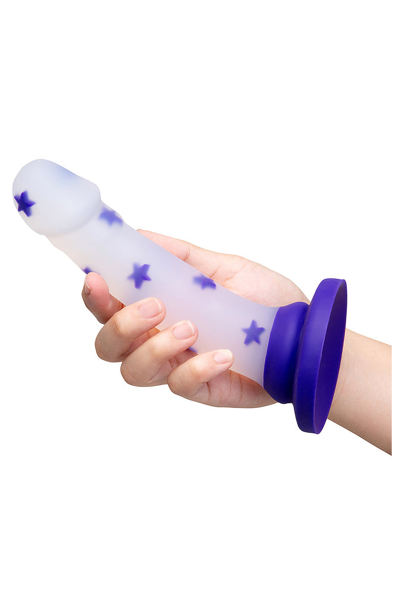 Hand holding the clear purple star dildo to show its size