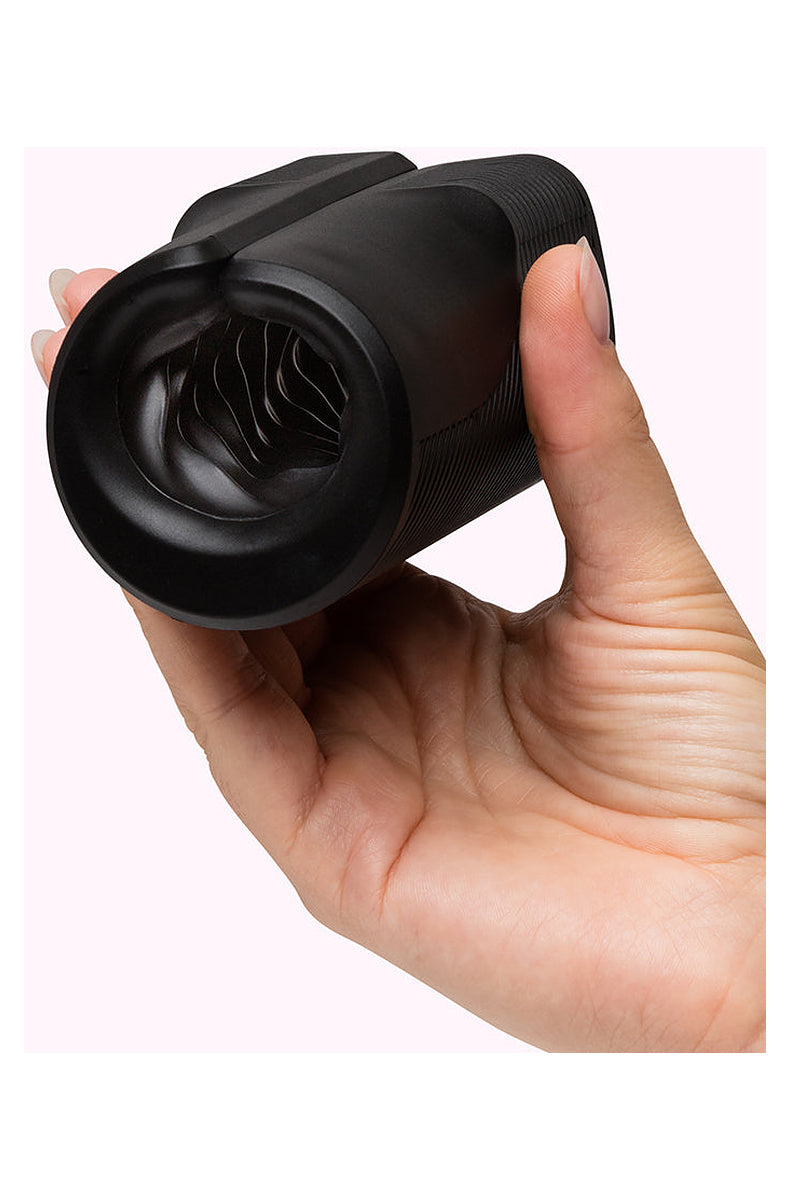Hand holding the black Arcwave Zing vibrating stroker