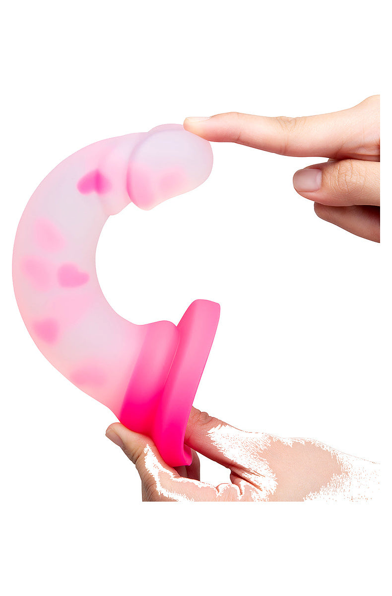 Clear pink heart silicone dildo bent in two hands to show how flexible it is