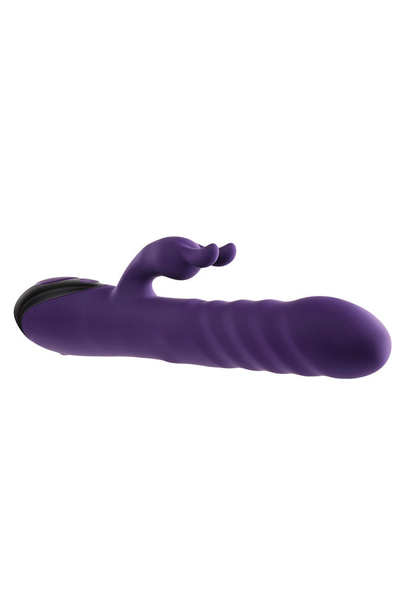 Purple Rascally Rabbit thrusting vibrator lying flat, showing its full 9 inch length and the rabbit arm.