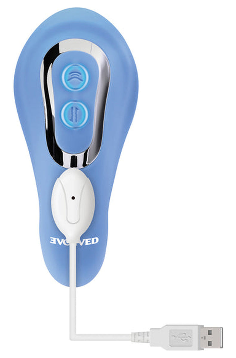 Blue Tap and Thrust dual stimulator with the included magnetic USB charging cable attached to the contacts.