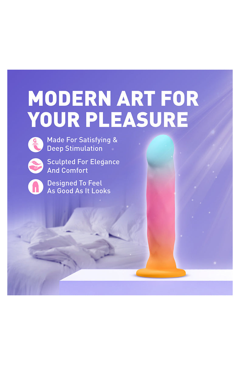 Aqua, pink and gold ombre dildo on a bed: made for satisfying deep stimulation, sculpted for elegance and comfort