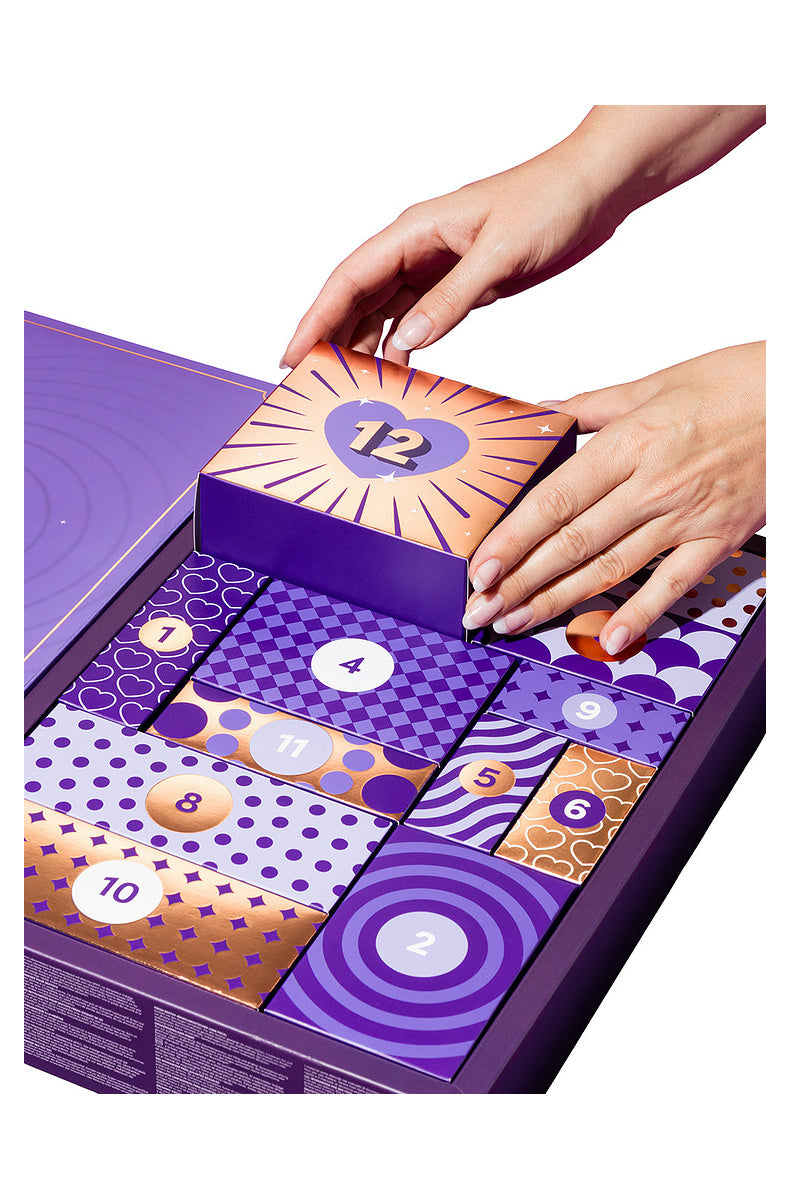 Hands lifting door 12 out of the open 12 day advent calendar