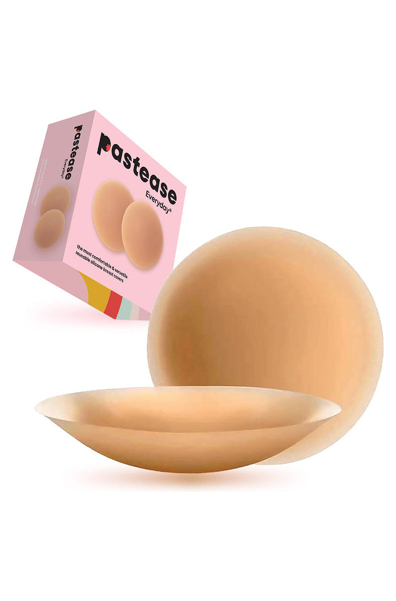 Medium tone round silicone nipple covers beside their retail box