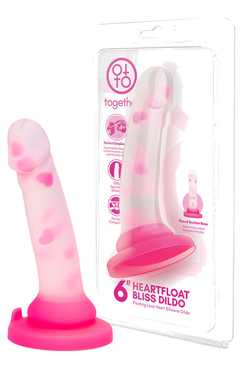 Clear pink heart dildo next to its retail box