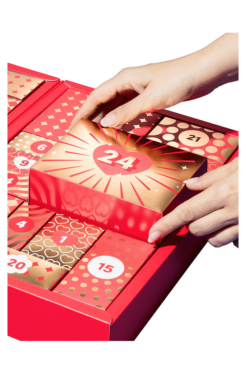 Hands lifting door 24 out of the open 24 day couples advent calendar