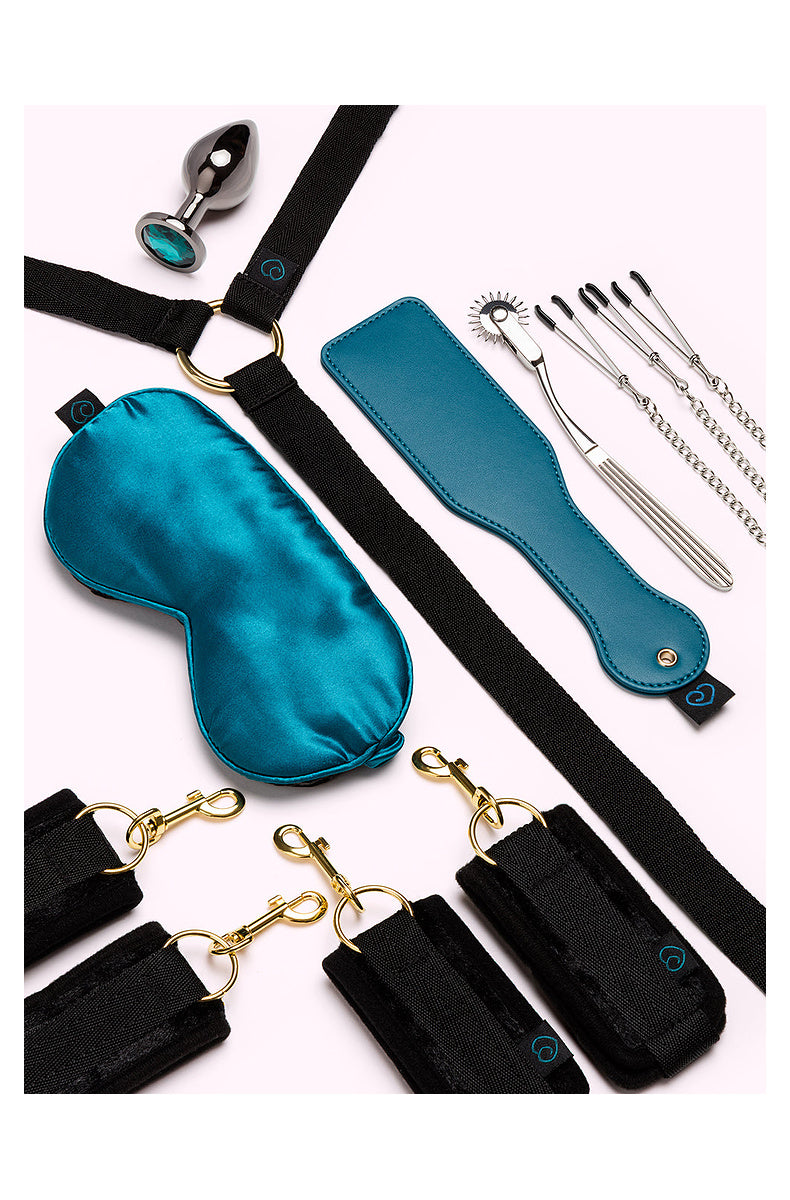 Teal satin blindfold, bed restraints, cuffs, paddle, pinwheel, clamp chain and jeweled plug