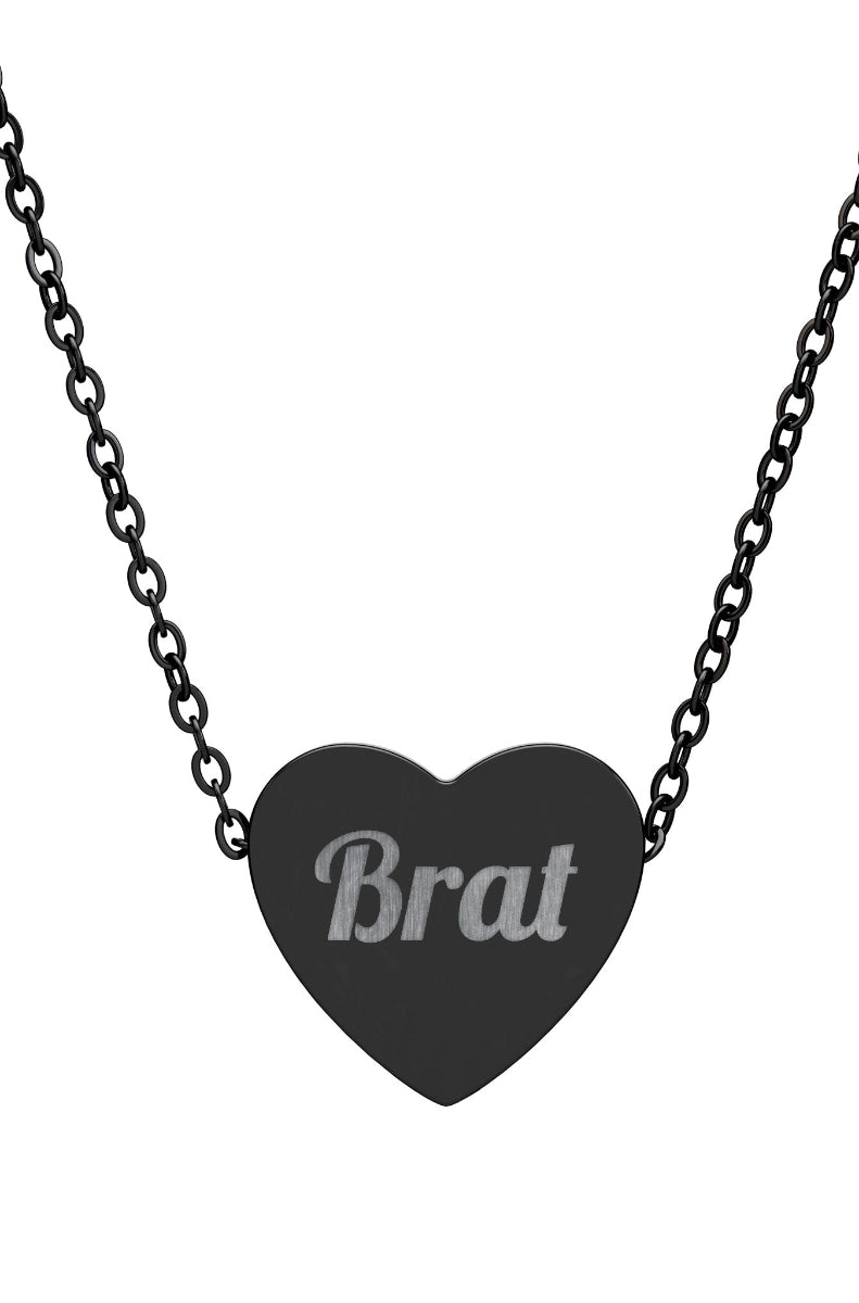 Heart-shaped pendant with 'Brat' engraving on a black chain against a white background