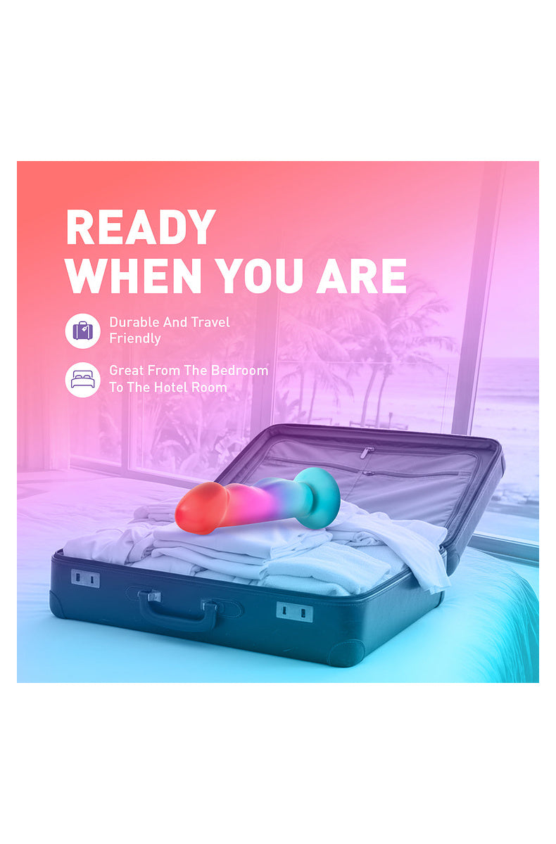 Coral, pink and aqua ombre dildo packed in a suitcase: durable and travel friendly