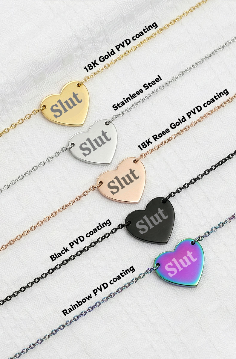 Heart-shaped 'Slut' pendant necklaces with various coatings on a white background