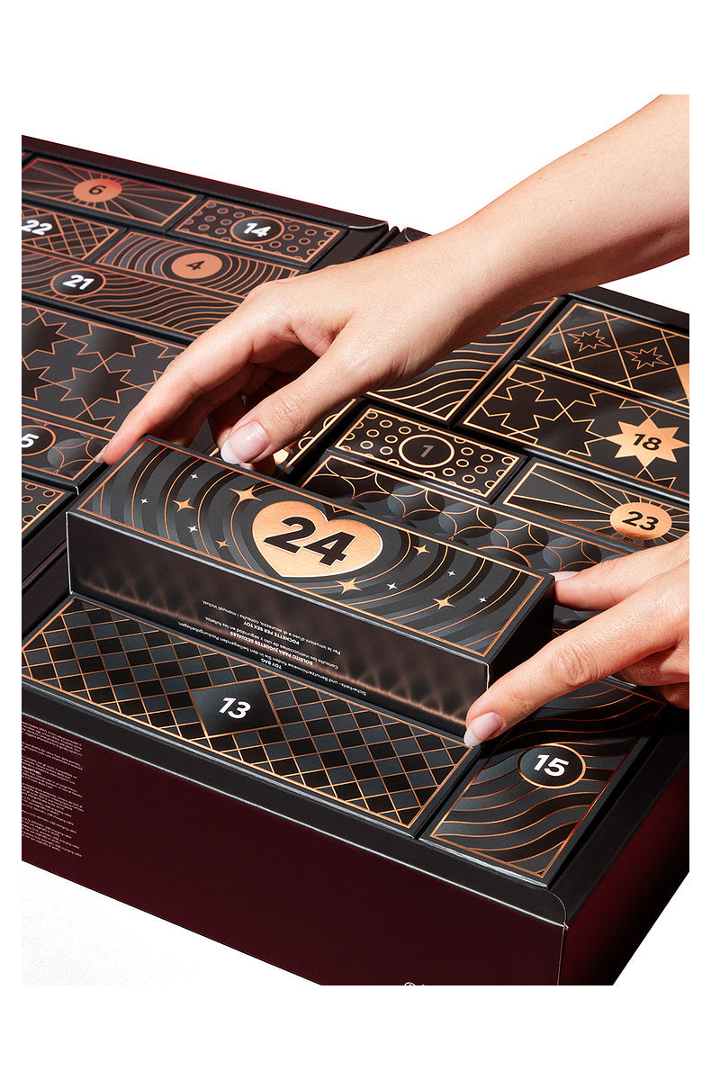 Hands lifting door 24 out of the open luxury advent calendar
