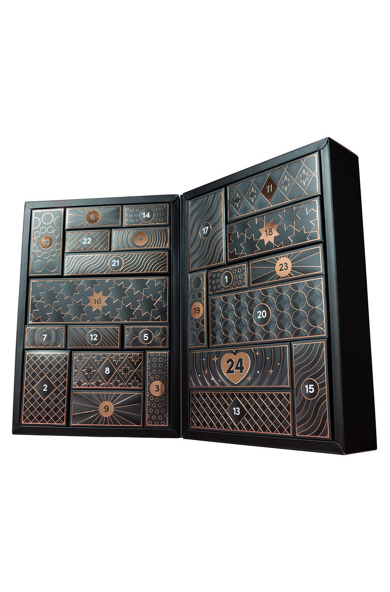 Open luxury advent calendar showing the numbered black and copper doors