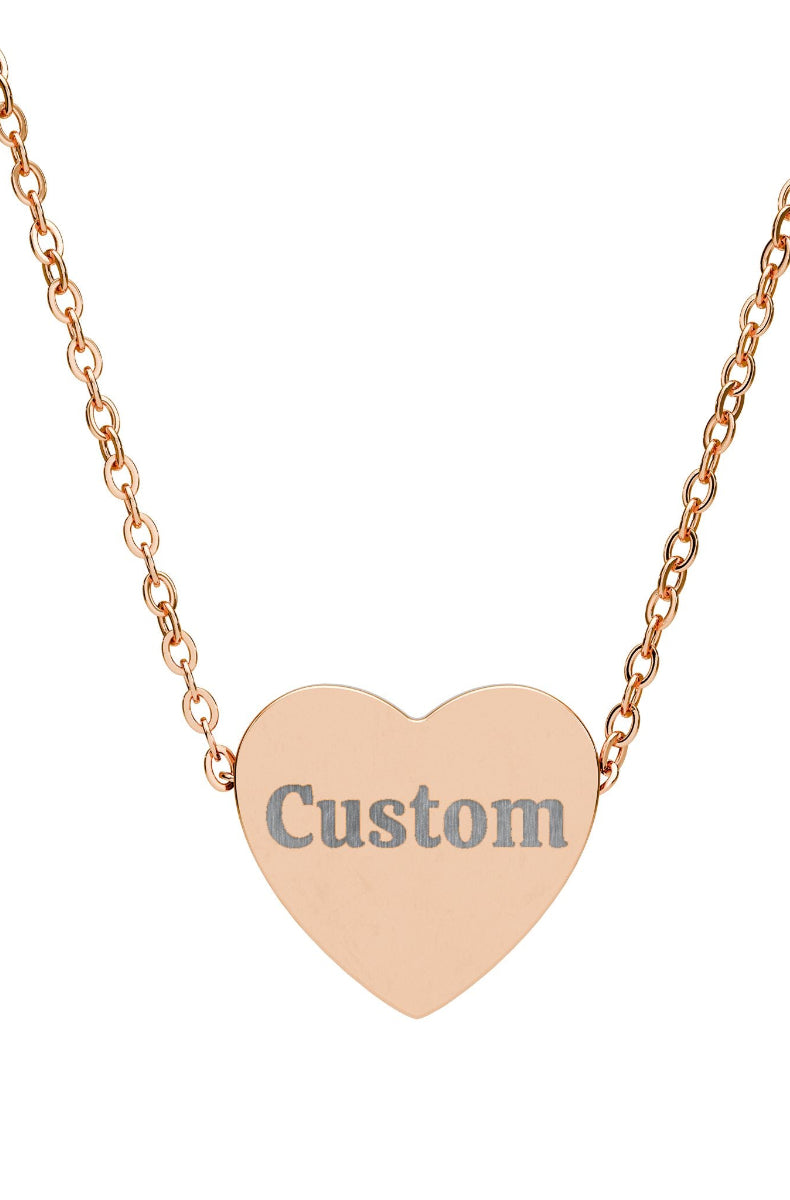 Rose gold heart-shaped necklace with 'Custom' engraving on a white background