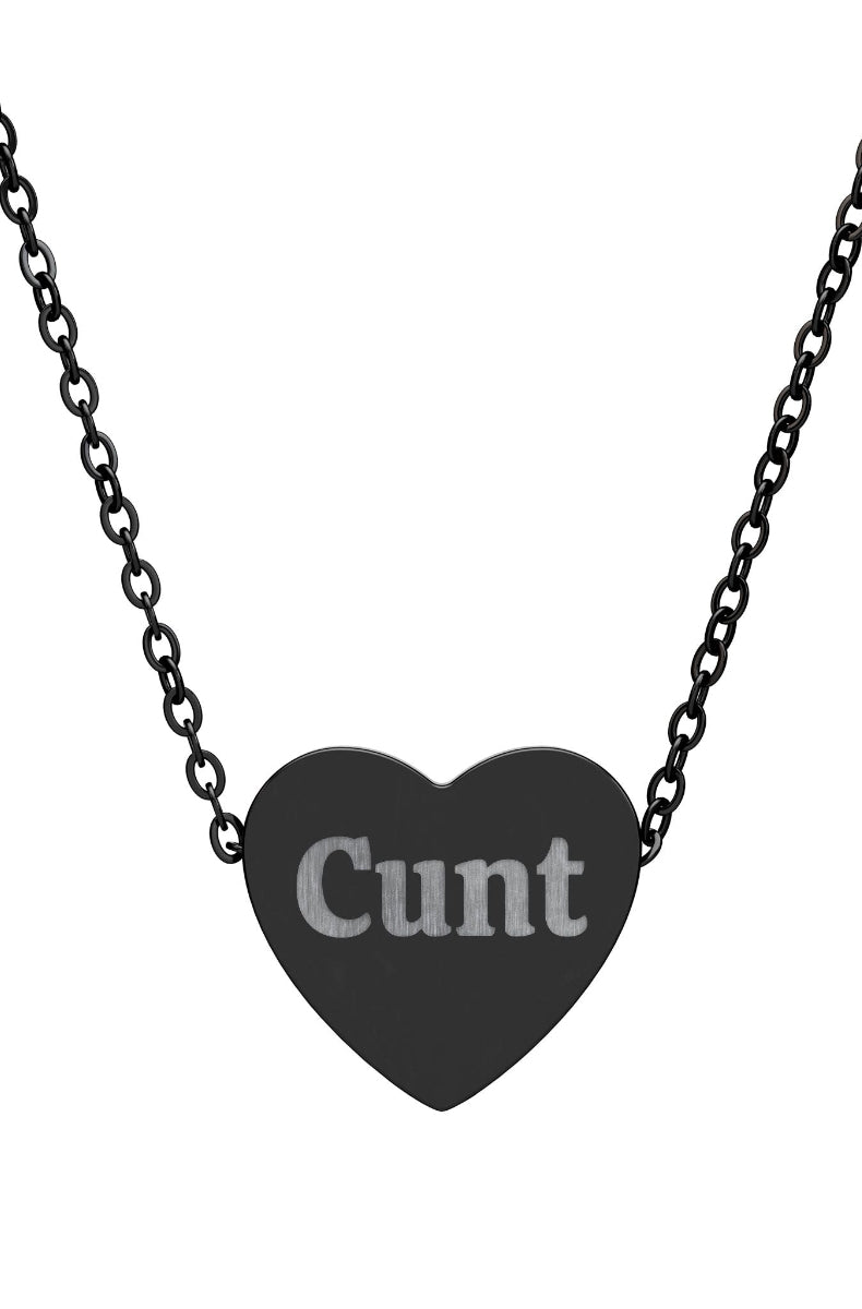 Heart-shaped pendant with the word 'Cunt' on a black chain against a white background