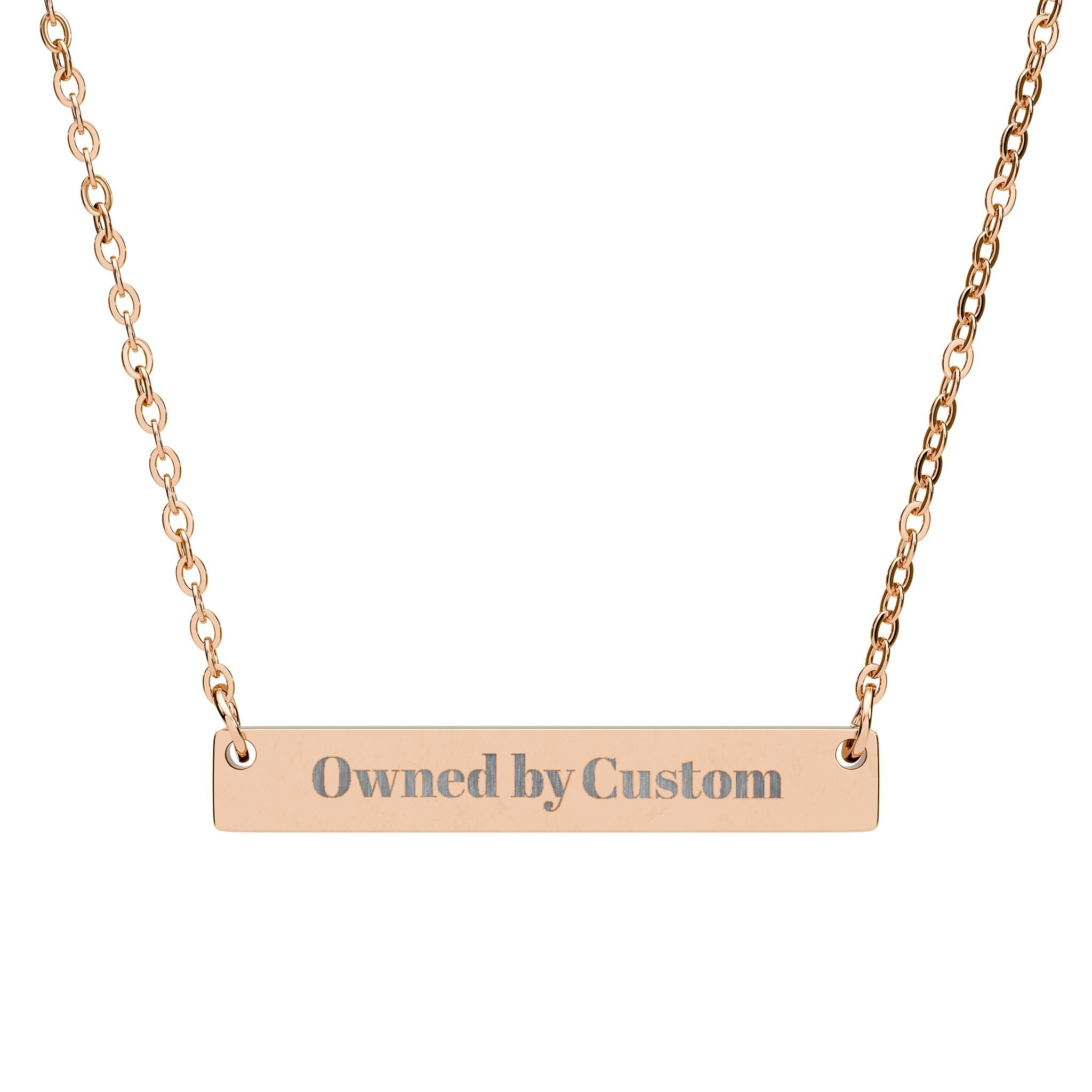 Rose gold necklace with 'owned by custom' pendant on a white background