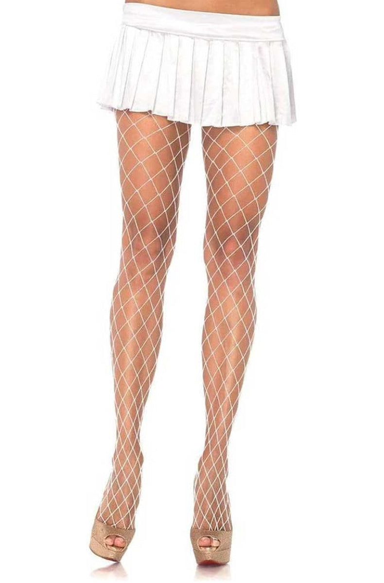 White diamond net tights worn with a pleated mini skirt
