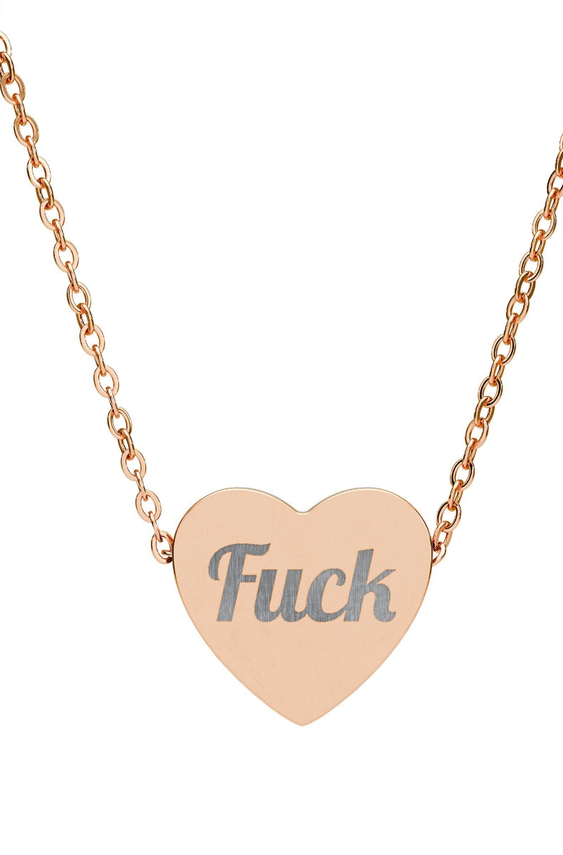 Heart-shaped pendant with the word 'Fuck' on a rose gold chain against a white background
