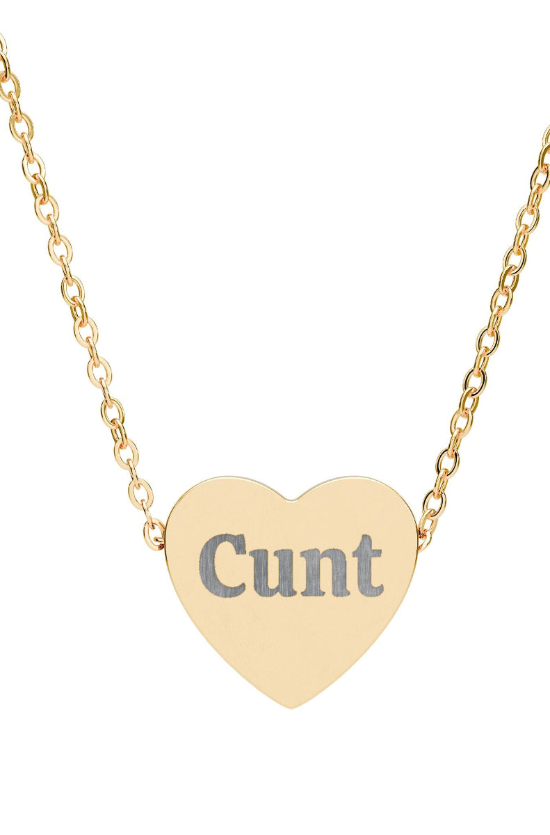 Gold heart-shaped necklace with the word 'Cunt' on a white background