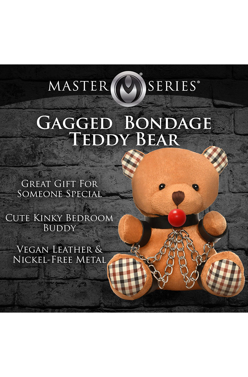 Detail view of checkered ear and black collar buckle on tan plush teddy bear head.