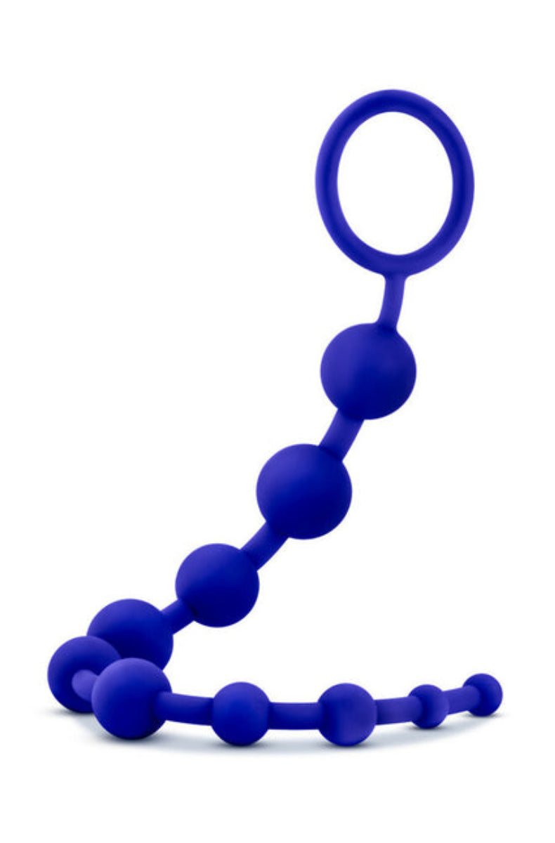 Indigo silicone anal beads, ten graduated beads with a looped ring handle at top right, on a white background.