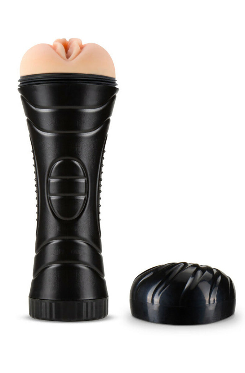 Blush M for Men Torch stroker with the beige X5 pussy sleeve at the top of the black flashlight canister, end cap off.
