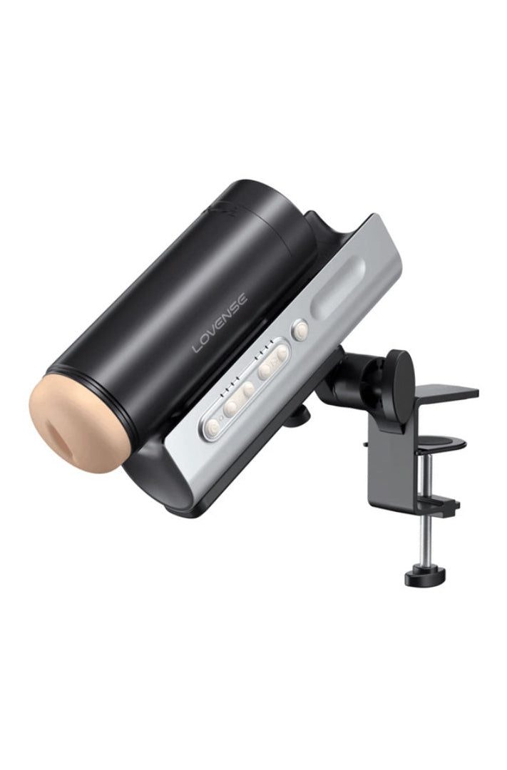 Black masturbator mounted on adjustable desk clamp with silver control dock positioned at angle