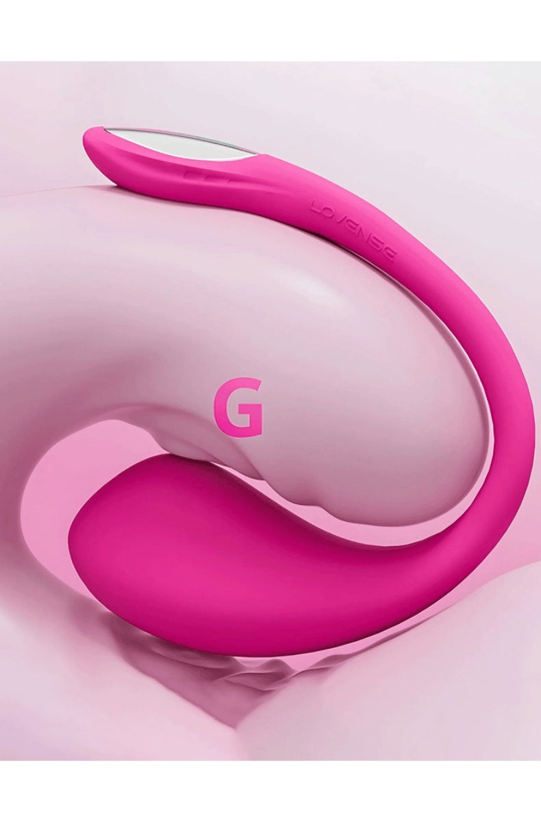 Pink curved vibrator on soft pink background with large G letter graphic overlay