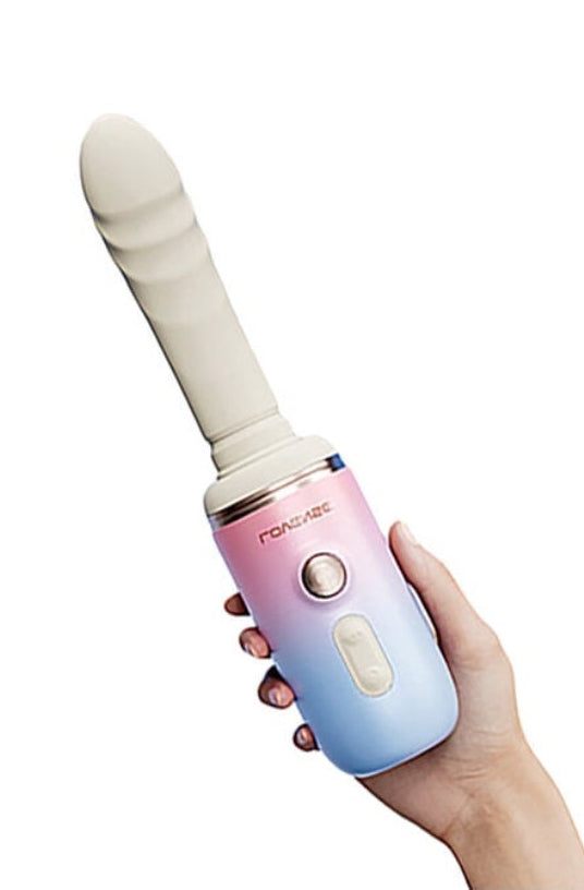 Hand holding blue-pink gradient vibrator showing ergonomic grip and control placement