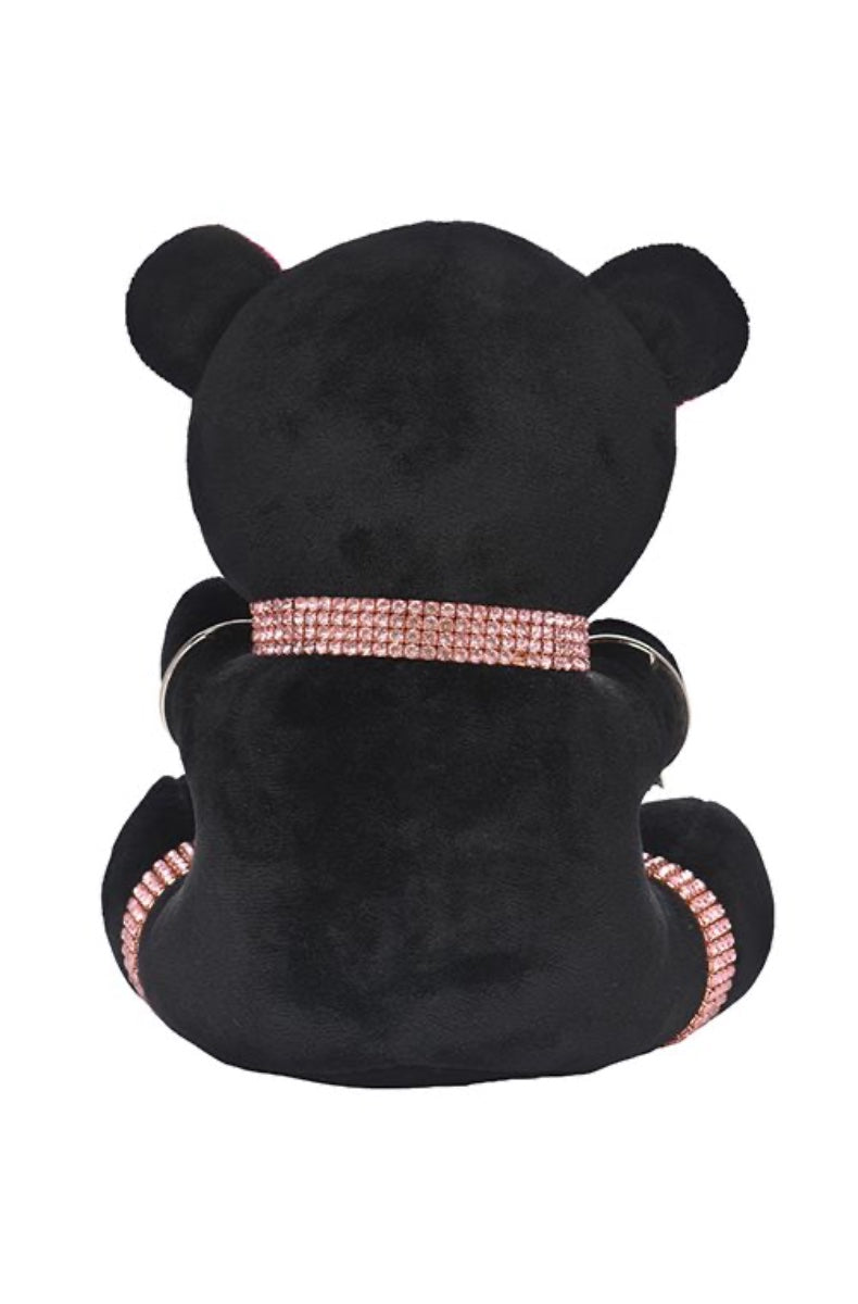 Back view of black plush teddy bear showing rhinestone collar with connecting chains and pink inner ears