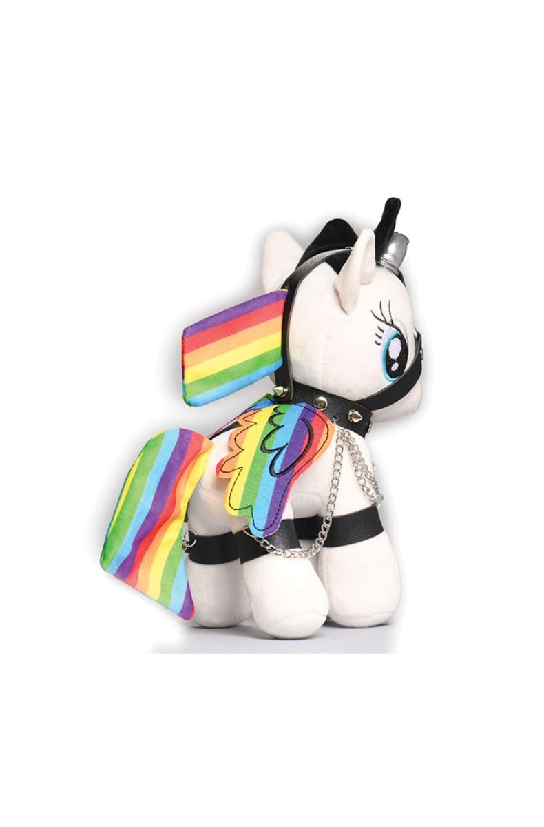 Back view of white plush unicorn showing rainbow striped wings and tail, black harness with silver studs