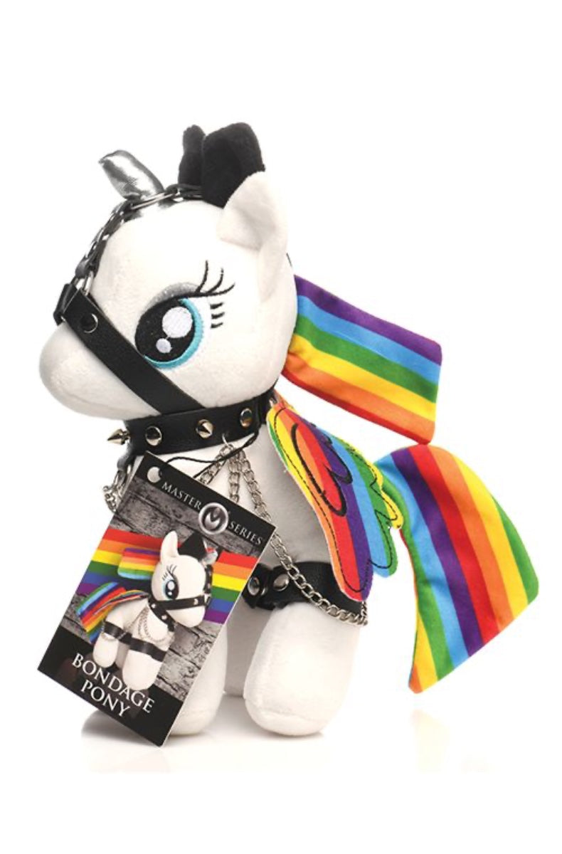 White plush unicorn with rainbow details in black leather bondage harness with chains and Master Series tag
