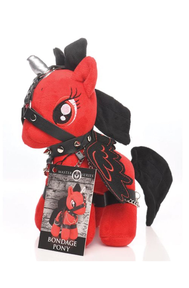 Side view of red bondage pony plush with black harness and silver horn on white background