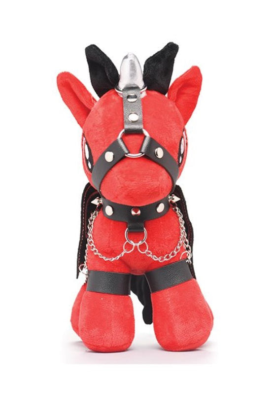 Front view of red plush pony with silver horn, black harness with studs, and product packaging