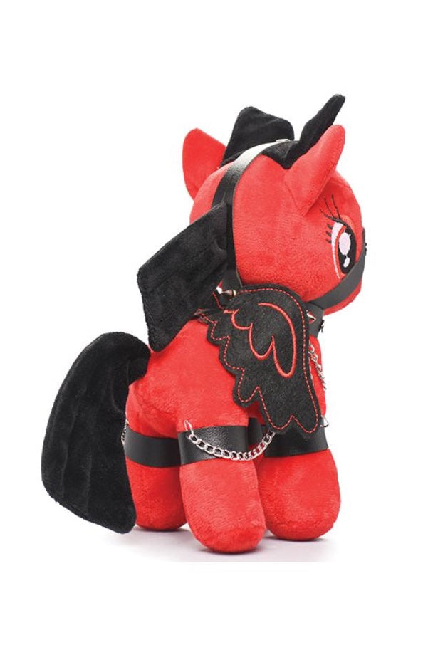 Back view of red plush pony showing black wings, harness with chains, and studded collar