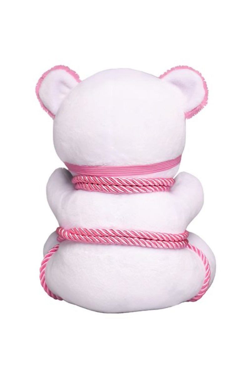 Back view of white plush bear with pink ears wrapped in pink twisted rope against white background