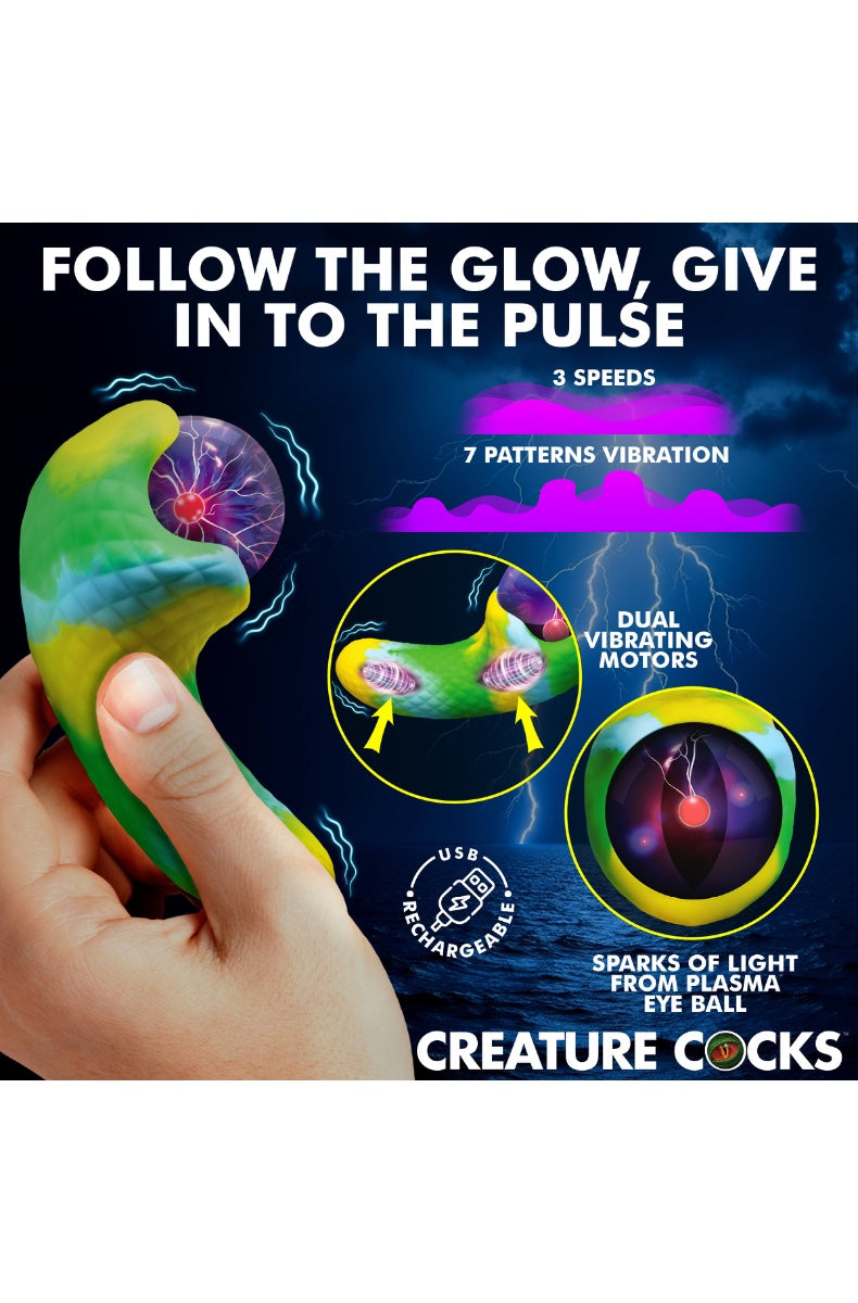Hand holding green-yellow gradient vibrator with glowing purple plasma eye against model wearing white lingerie