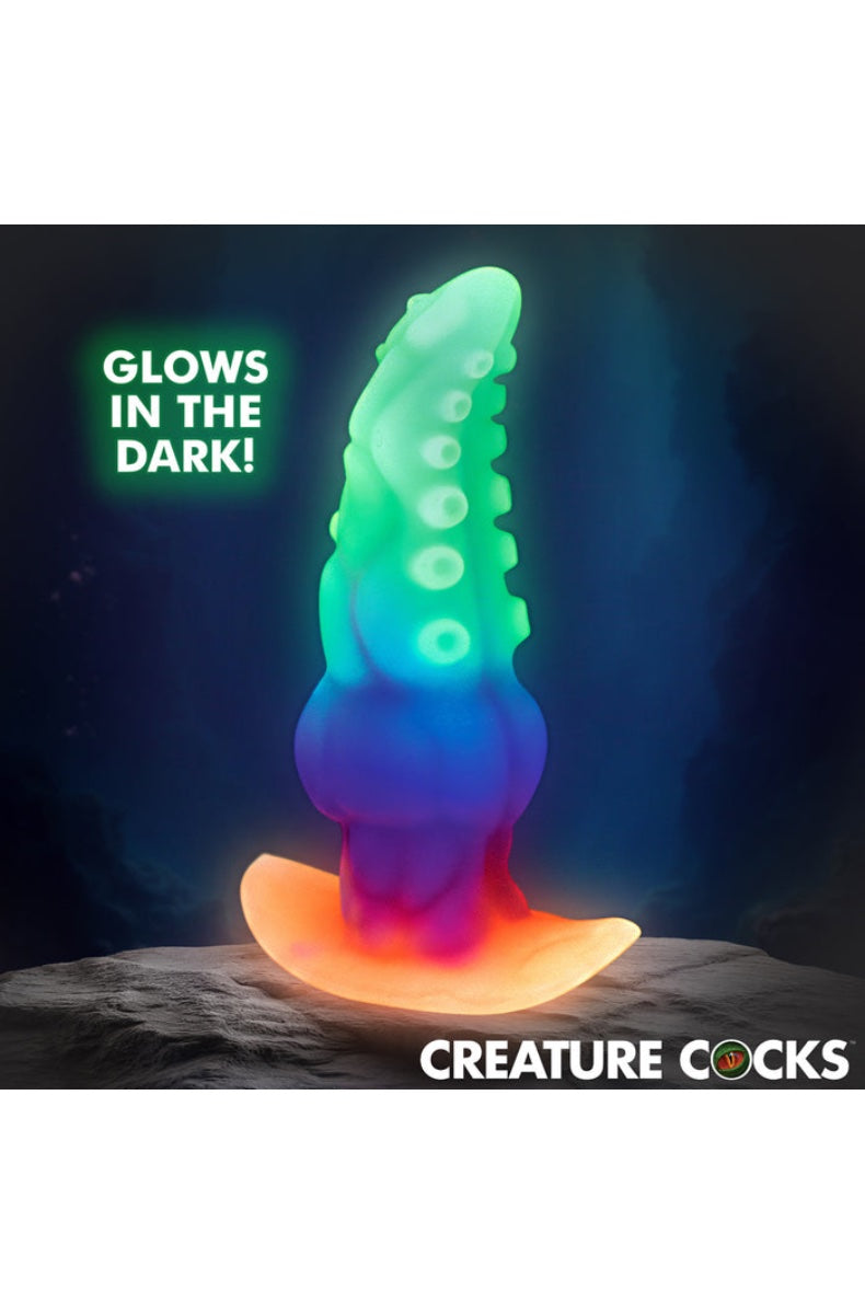 Glow-in-the-dark tentacle anal plug showing green luminescent texture against dark background