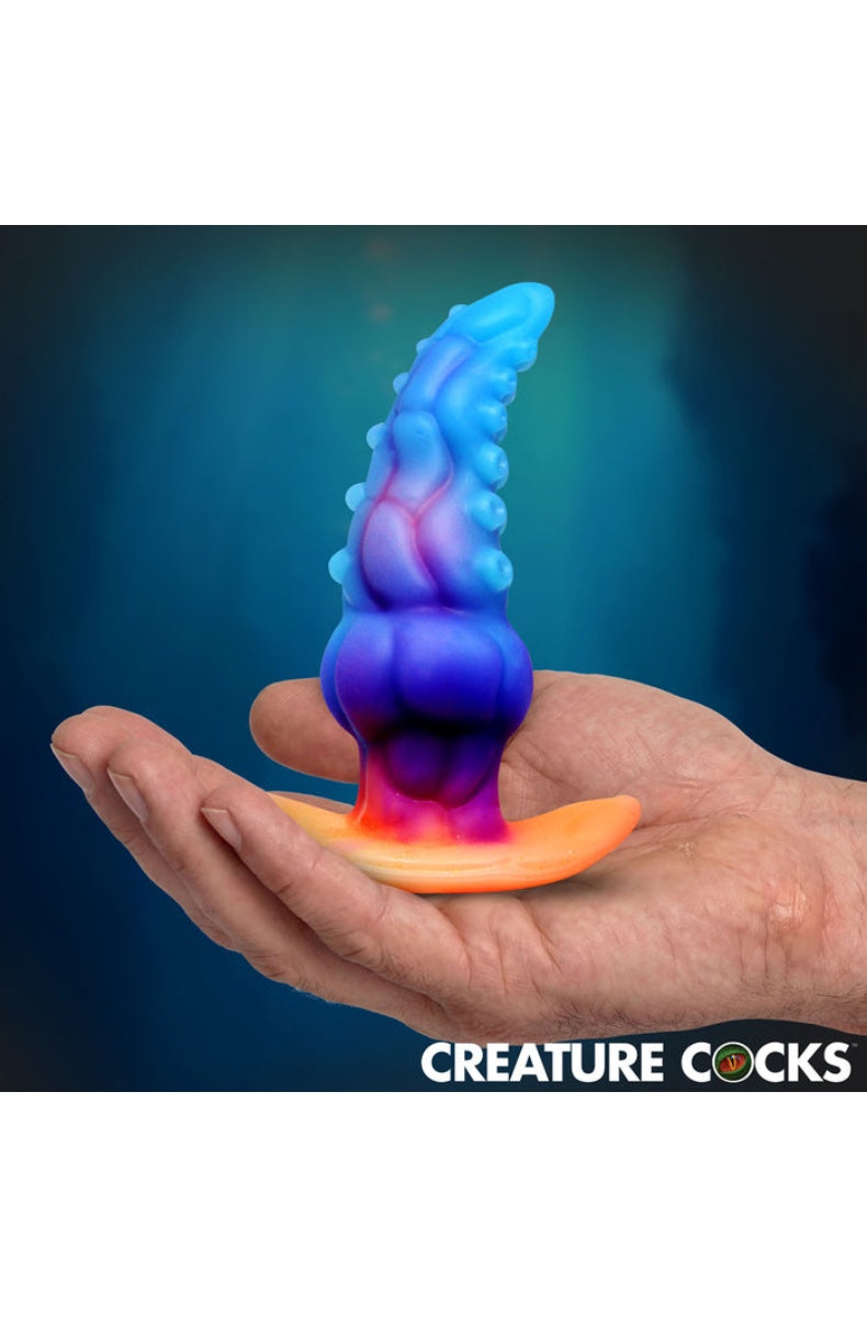 Side view of blue-purple gradient tentacle plug with sucker details and orange base