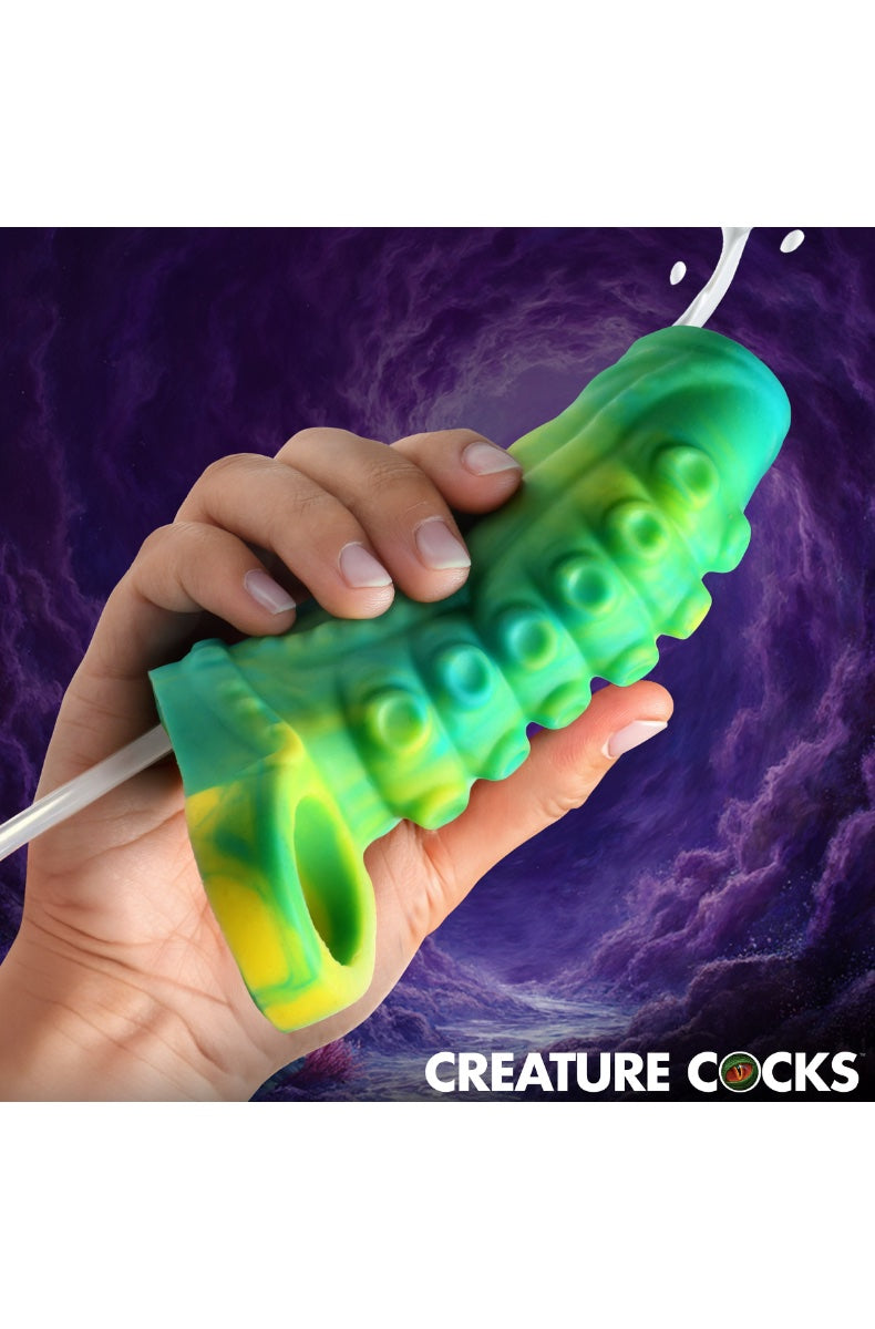 Hands gripping teal-green textured tentacle sleeve showing ridged surface texture and open tip design