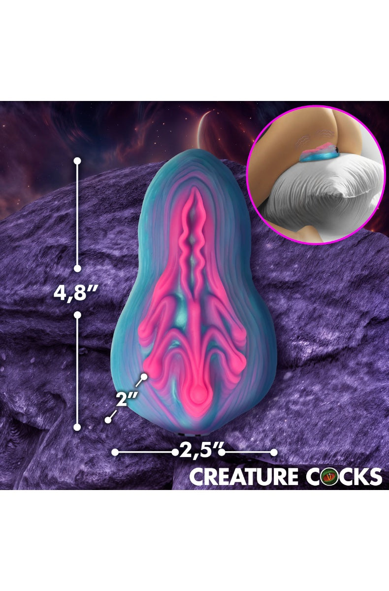 Side view of alien vulva grinder showing textured folds and dimensions, 4.8 inches length on purple alien landscape background