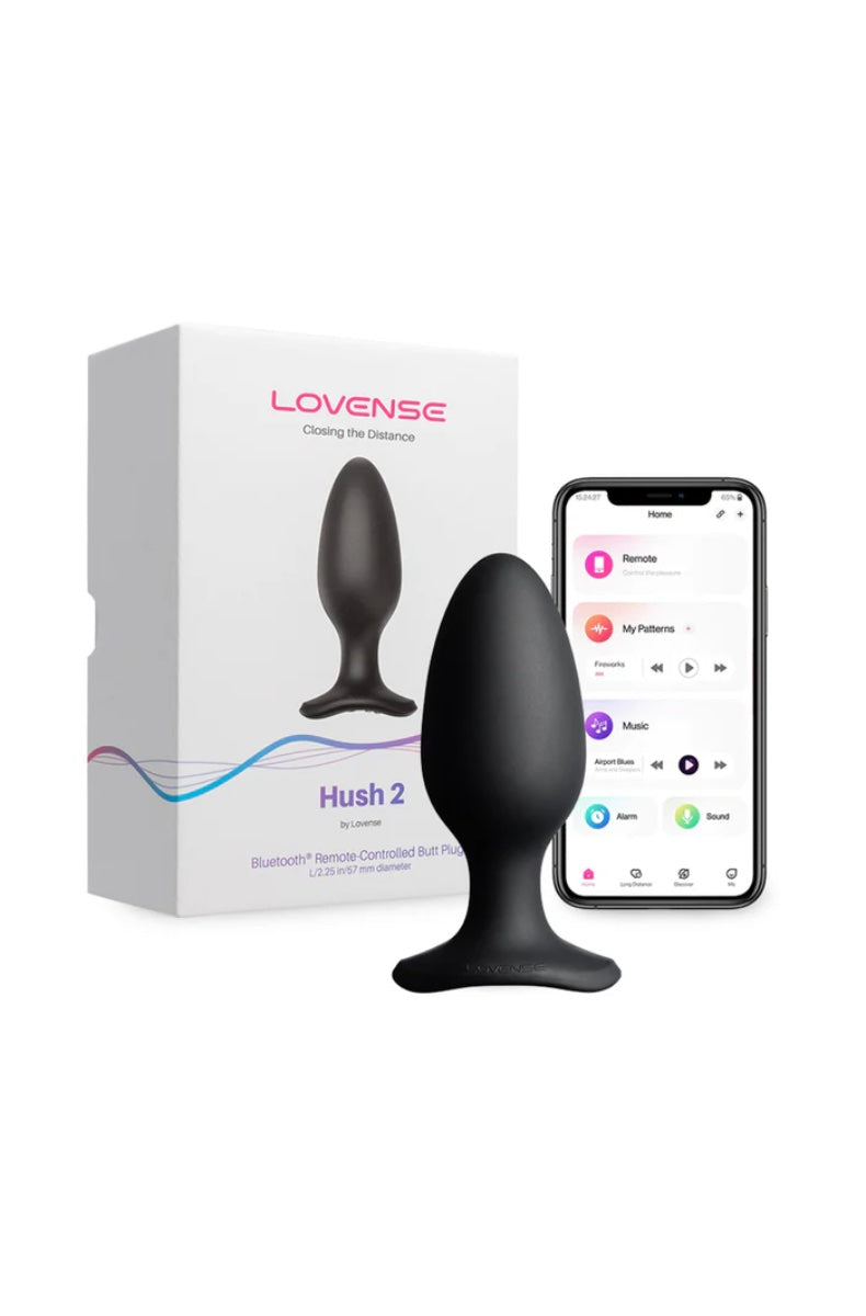 Black teardrop-shaped butt plug with flared base next to white retail box and smartphone showing Lovense app